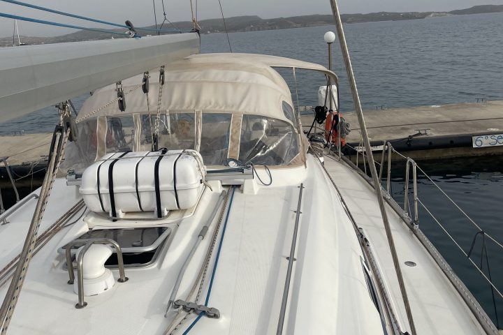 View from a yacht's deck toward the horizon, docked at a marina.
